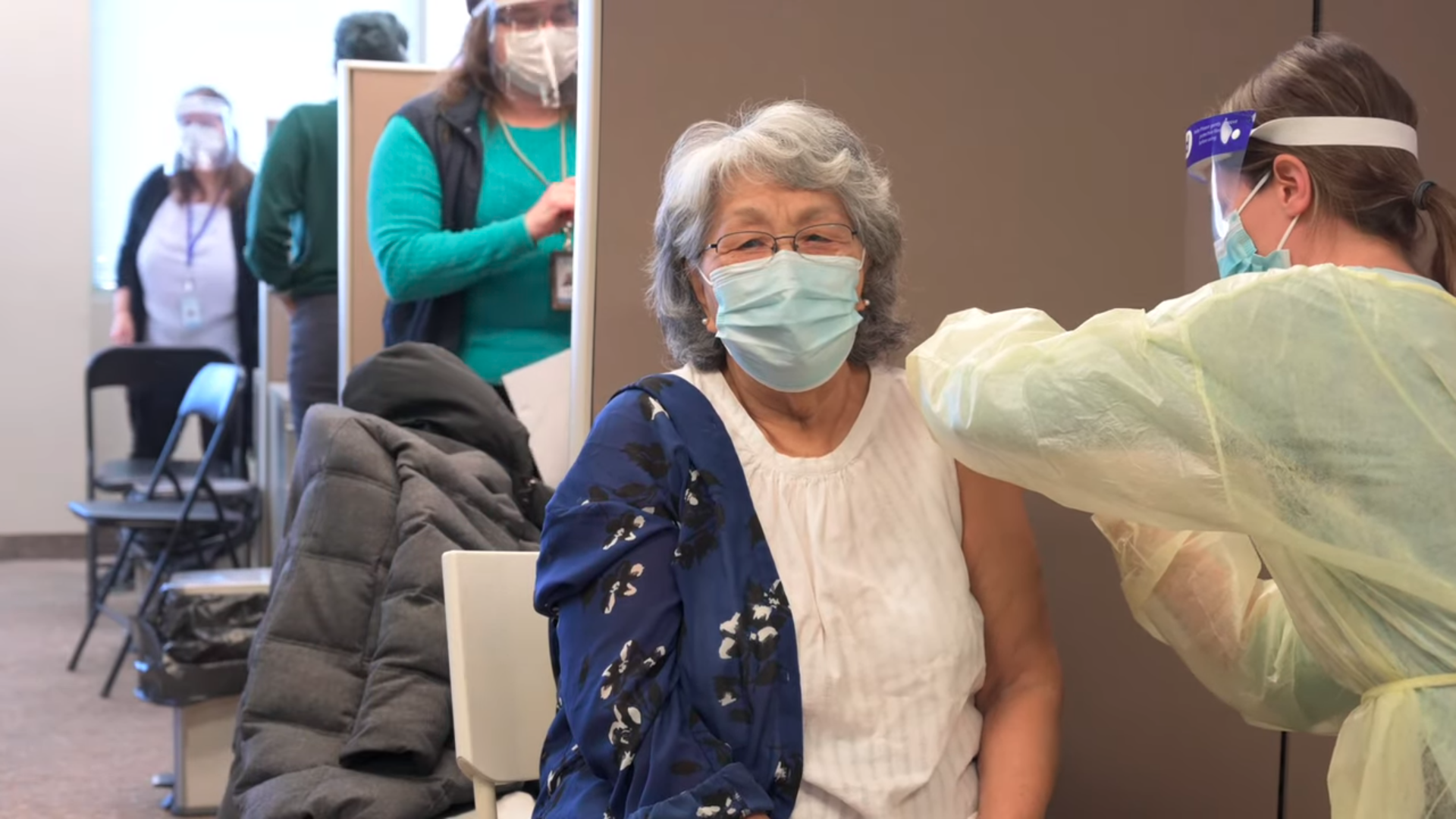 Akausivik Inuit FHT healthcare provider administering COVID-19 vaccine to community member