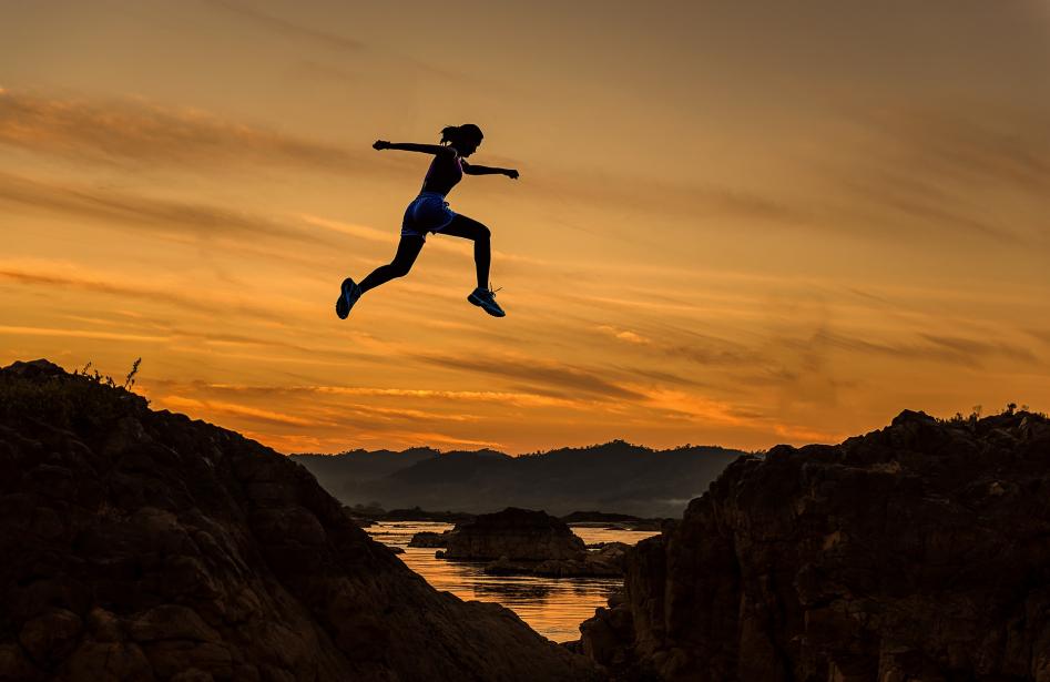 Woman jumping over gap