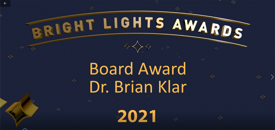 2021 board award winner video Screenshot of opening of 2021 board award winner video. Logo at top with Board Award, Dr. Brian Klar 2021 below. Background is navy blue with gold stars.